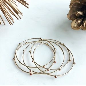 JCrew set of 5 gold bangles w/orange insets